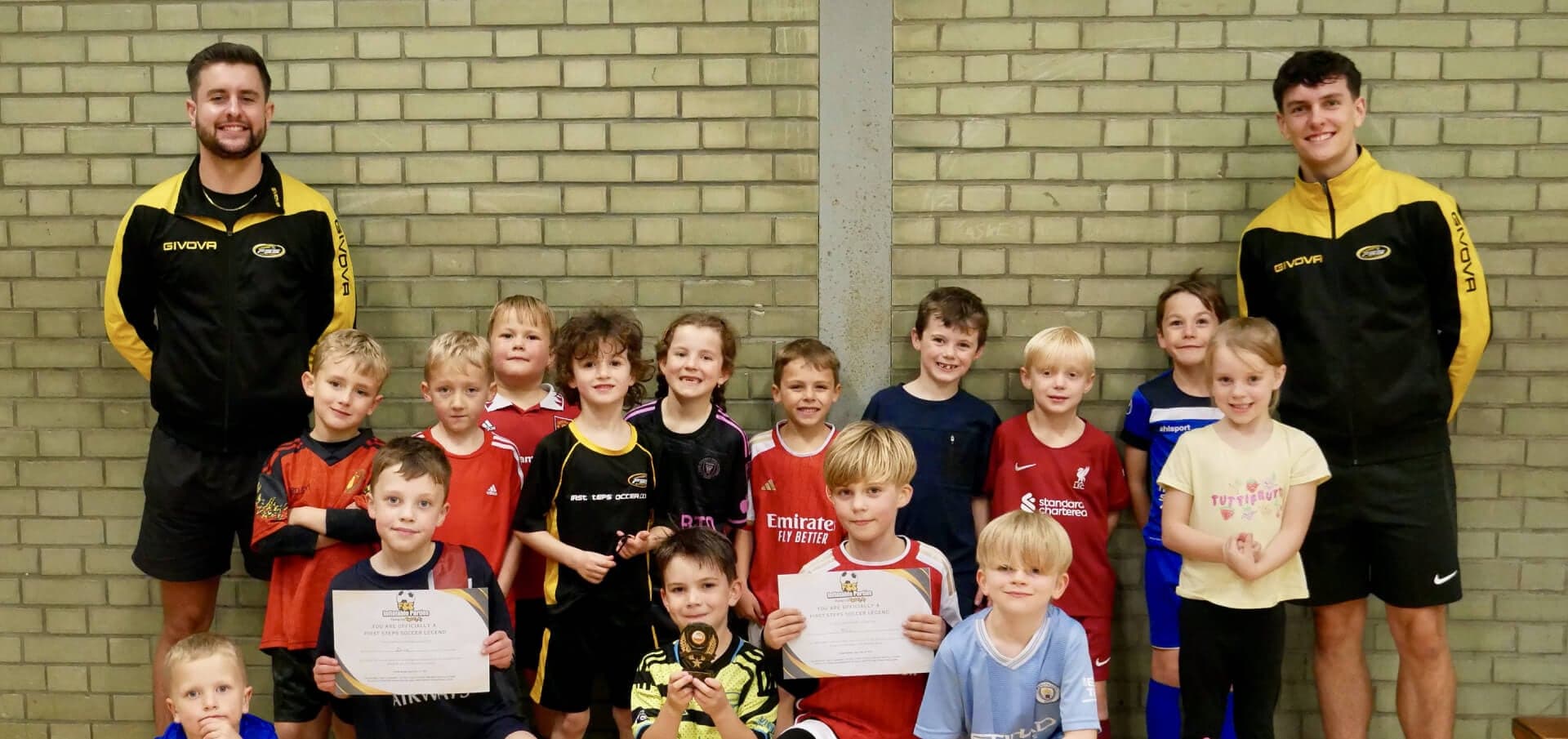 FSS coaches with a group of children holding their certificates