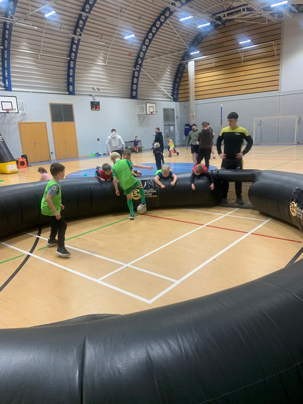 Children playing inside the FSS inflatable football pitch